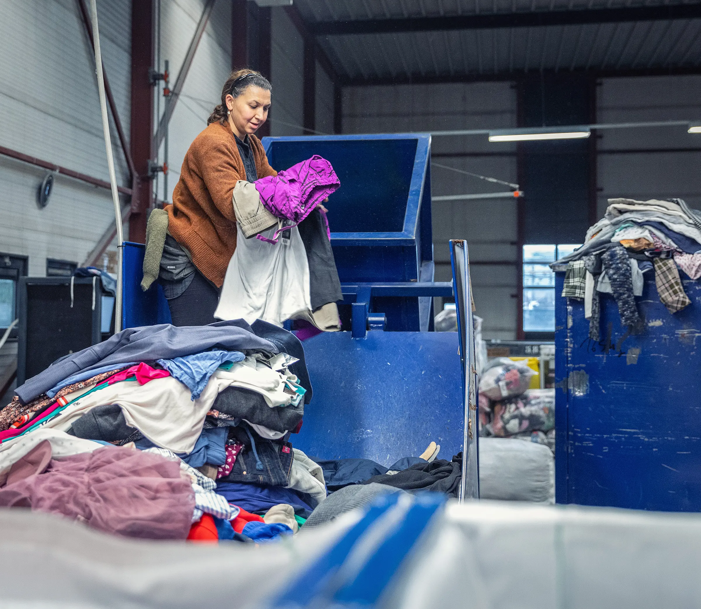 Employee empties a Xycles container